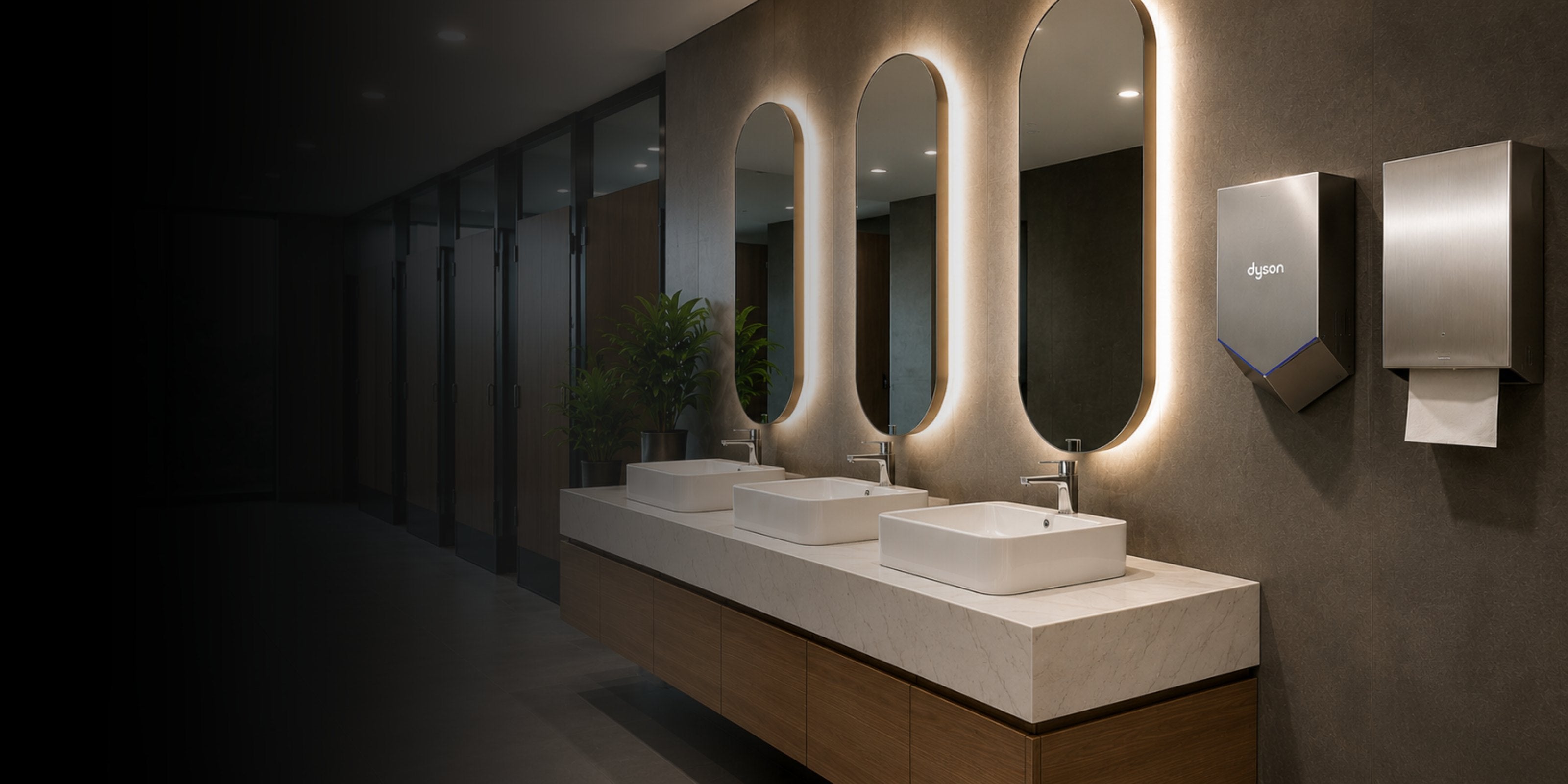 Bathroom vanity with illuminated mirrors and modern fixtures.